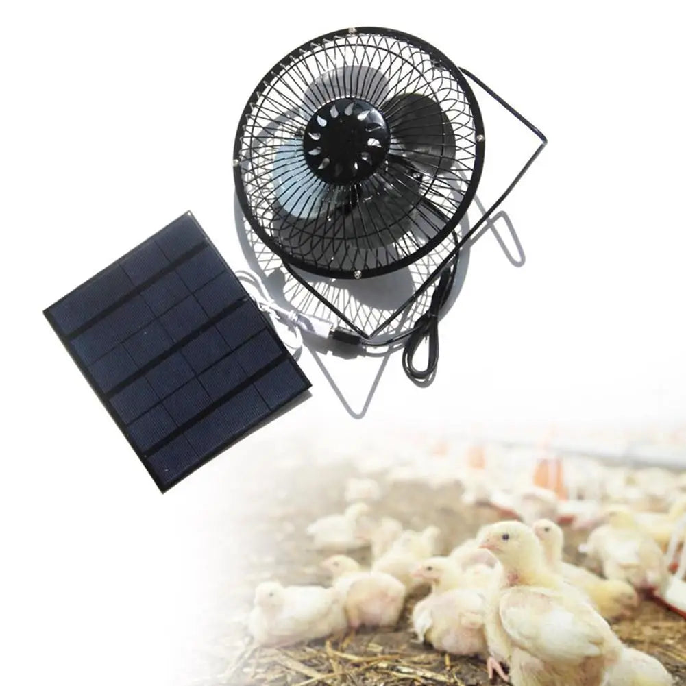 Solar-powered fan with a solar panel on a white background, with chicks in the background.