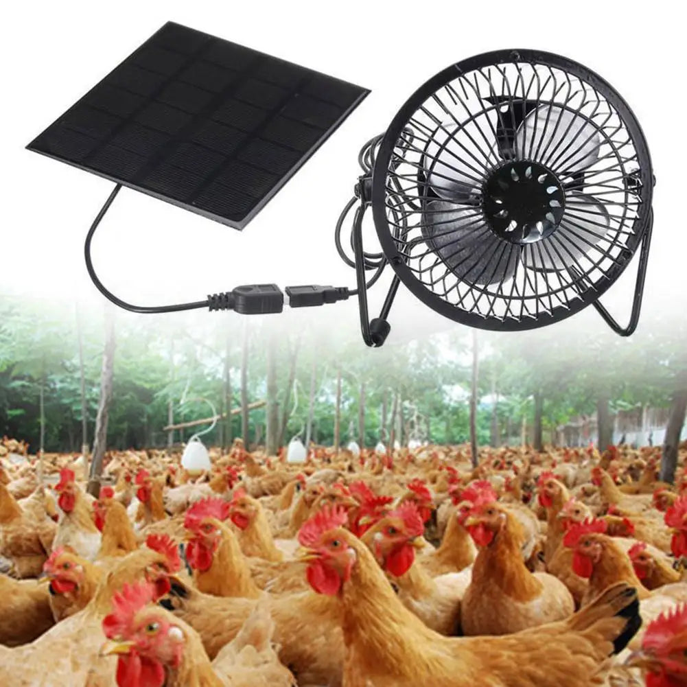 Solar panel and fan with a background of chickens in an outdoor setting